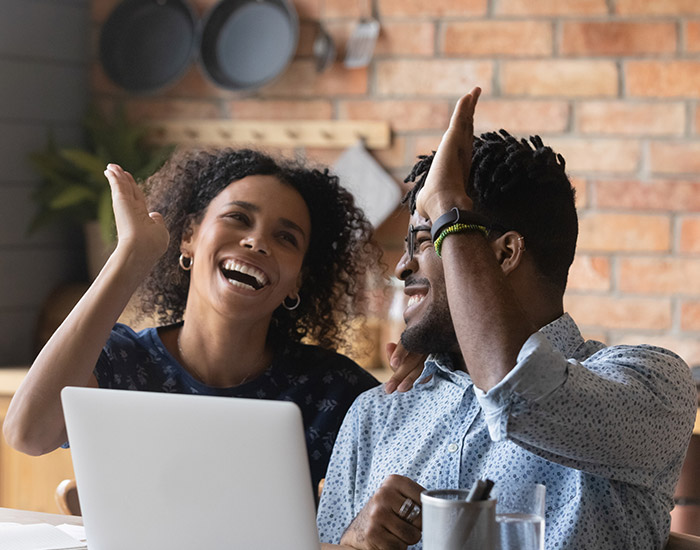 Two happy people realize their social media contest was executed correctly and was fully compliant