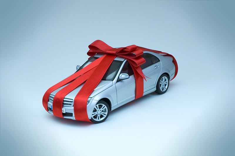A ribbon wrapped undefinable model car as a gift.