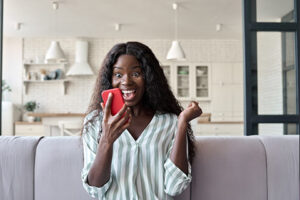 women feeling happy looking at her phone